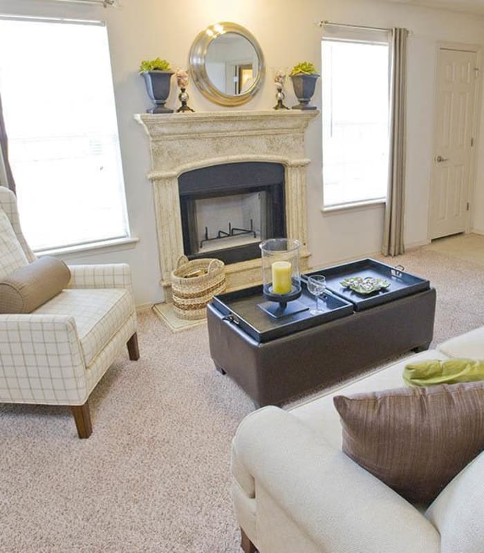 Carpeted living room at Villas at Stonebridge in Edmond, Oklahoma