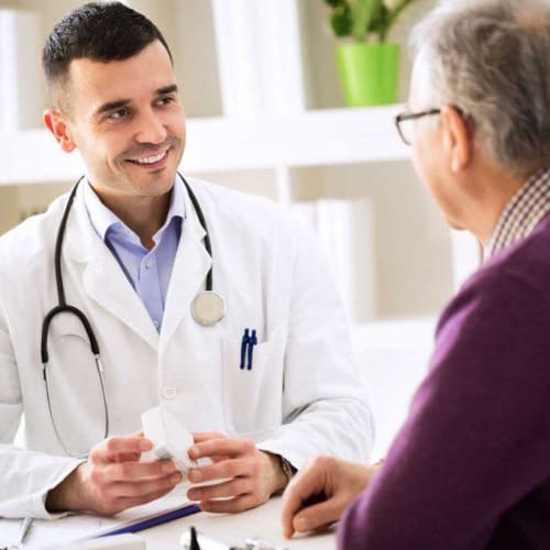 A doctor talking to a resident at Fair Haven in Birmingham, Alabama. 