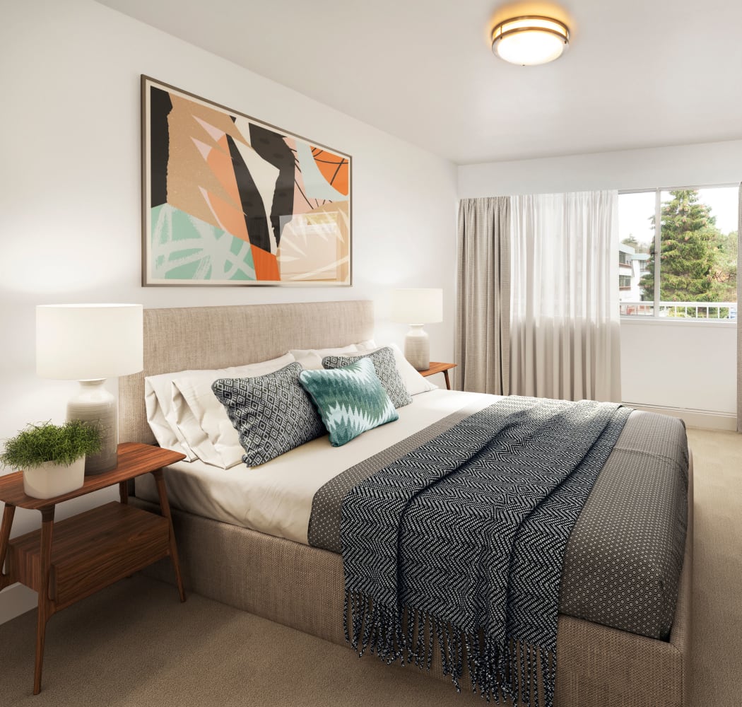 Beautiful model bedroom with unique art decor at Fraser Tolmie Apartments in Victoria, British Columbia