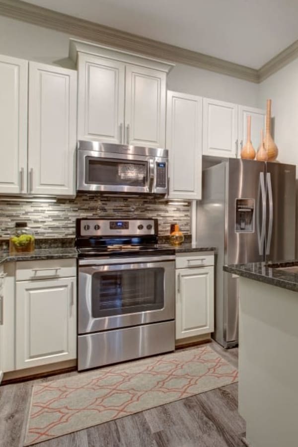 Huge island in the kitchen with nice wood style flooring at Mark at West Midtown in Atlanta, Georgia