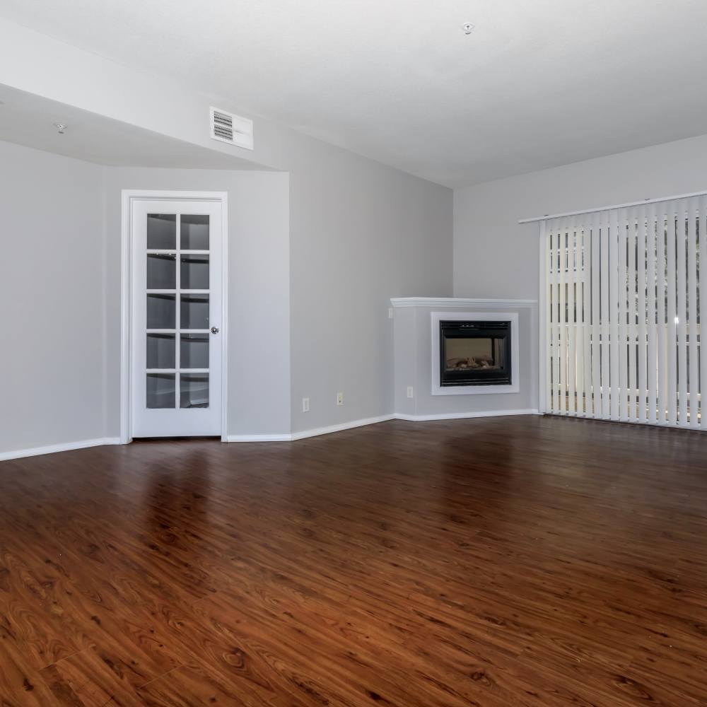 Unfurnished living room with access to patio at One Belmar Place in Lakewood,Colorado