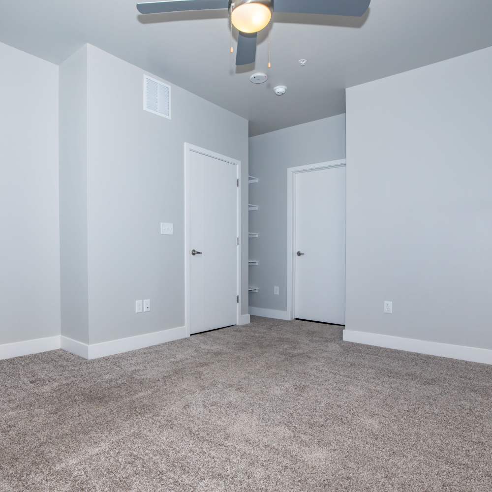 Bedroom with storage area and carpet flooring at Park Place Olde Town Apartments in Arvada, Colorado