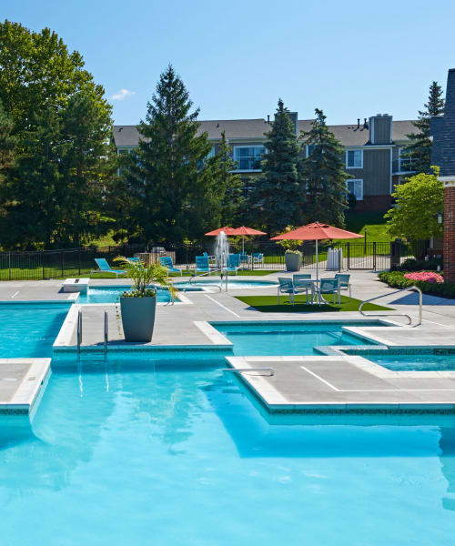 Outdoor swimming pool with expansive pool deck at Citation Club in Farmington Hills, Michigan