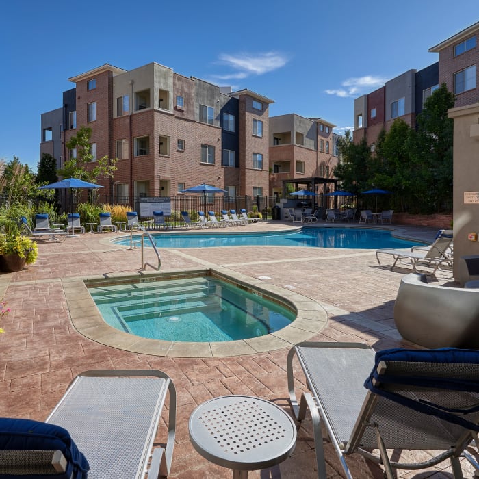 Swimming pool view with lounges and covered BBQ area and spa at The Rail at Inverness in Englewood