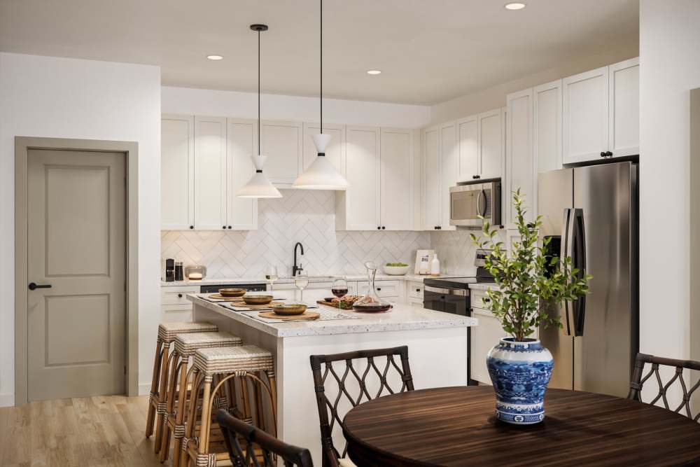 Modern kitchen with island and stainless steel appliances at Romero Apartments in Pensacola, Florida
