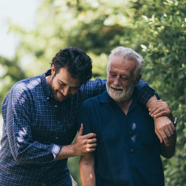 A resident and his son taking a stroll at Pacifica Senior Living Menifee in Sun City, California.