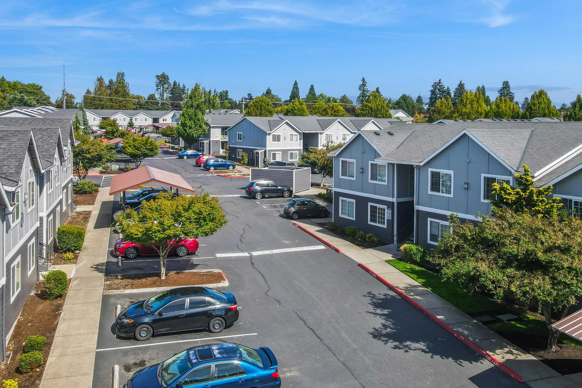 Aerial view of apartments with wide parking space at The Addison Apartments in Vancouver, Washington