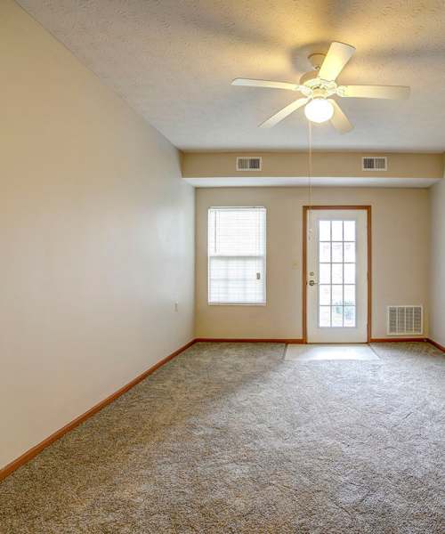 Beautiful apartment with ceiling fan and carpet flooring at Brentwood Greene in Kokomo, Indiana
