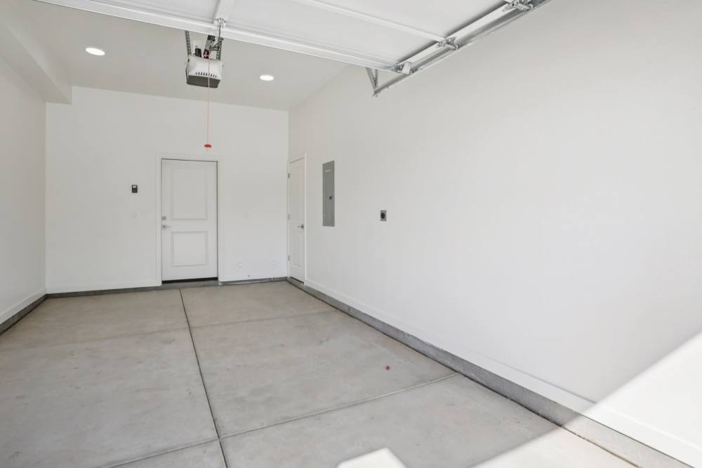 A white room with a door and a window.