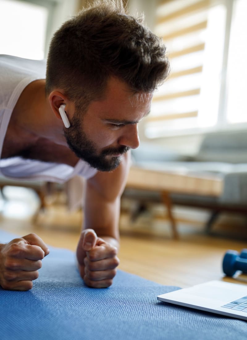 Resident working out in living room at Marquis at Great Hills in Austin, Texas