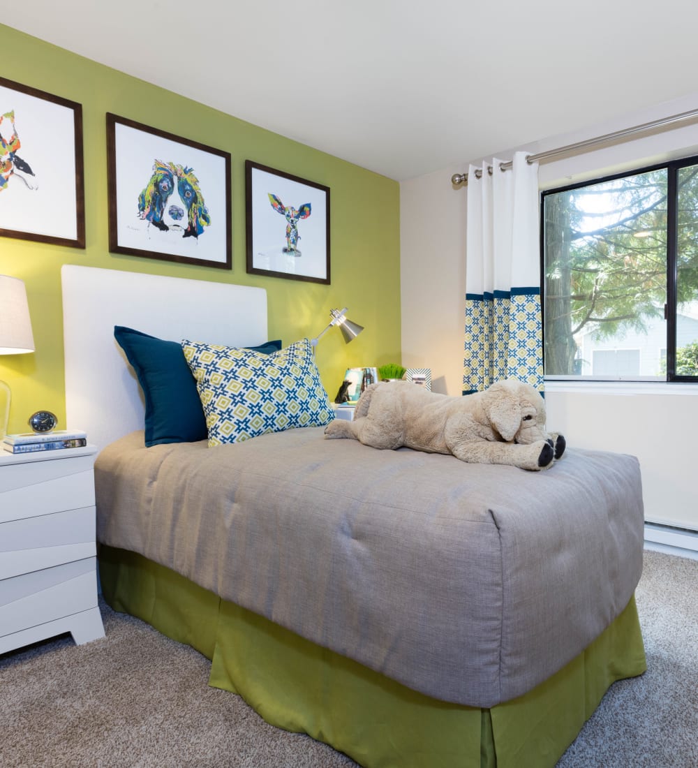 Well-decorated bedroom in a model home at Madison Sammamish Apartments in Sammamish, Washington