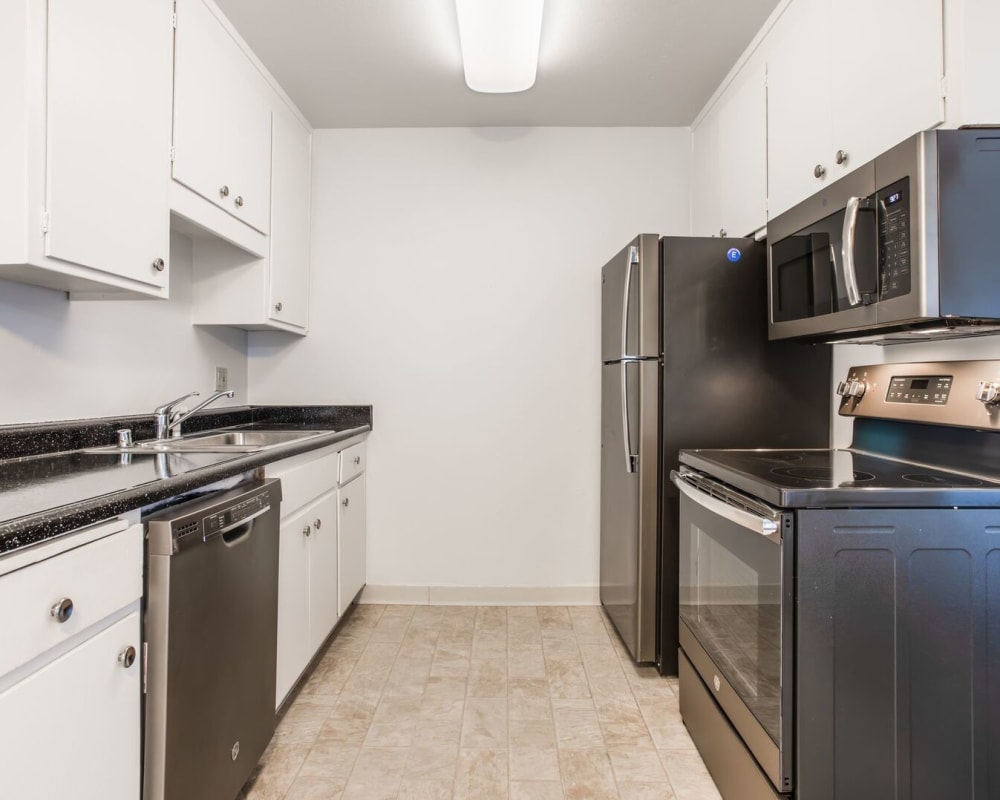 Kitchen with tiled floors and modern appliances at Courtyard in Hayward, California