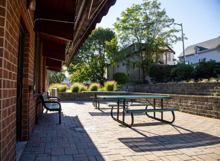 Outdoor space with a delightful courtyard and benches at Borden Place Apartments in Fall River, Massachusetts