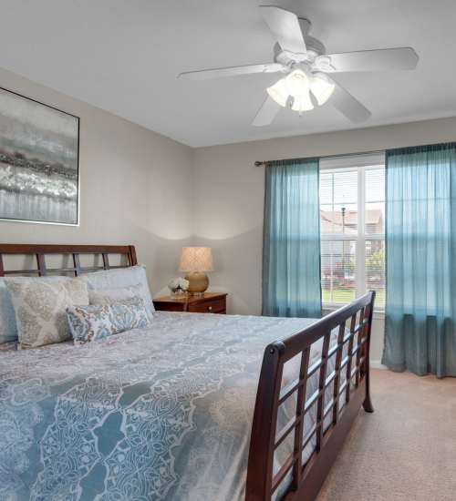 Comfortable bedroom with ceiling fan at Reserve at Northshore in Lynn Haven, Florida