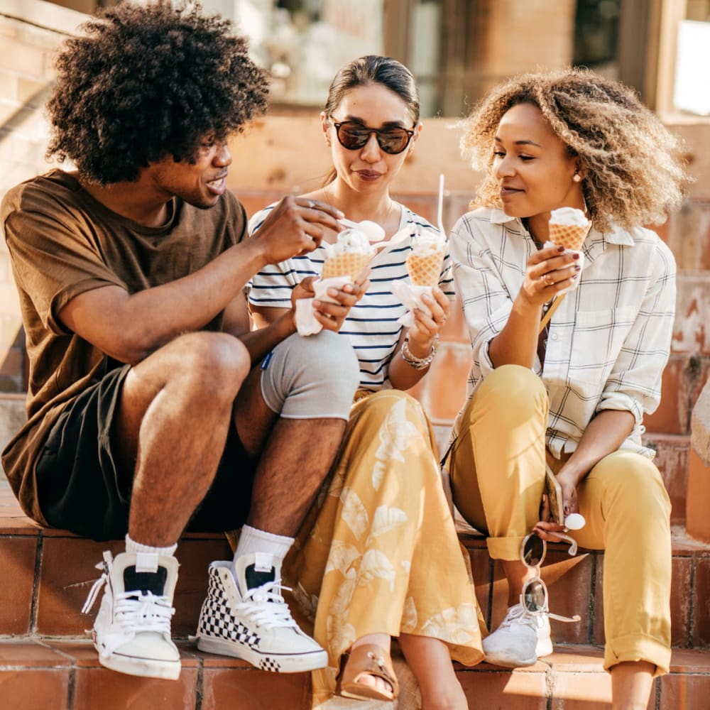 Resident friends enjoying some ice cream on a stoep downtown near Oaks Glen Lake in Minnetonka, Minnesota