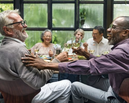 Residents out for a meal together with lots of vegetation outside at The Adair in Charlotte, North Carolina