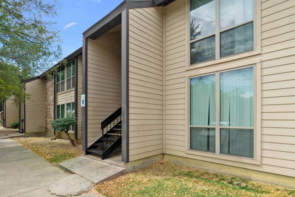 Exterior view of the apartment with stair case to upper level at Woodland Village Apartments in Breckenridge, Texas