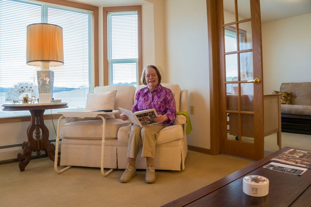 Resident enjoying comfortable living room at Meadow Lakes Senior Living in Rochester, Minnesota.