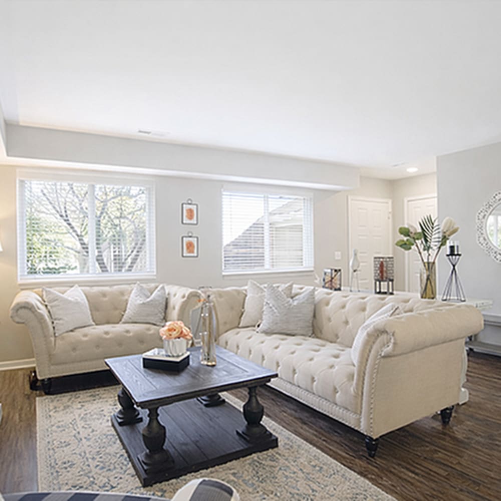 Chic tufted sofa with decorative accents at 83 West Townhomes in West Bloomfield Township, Michigan