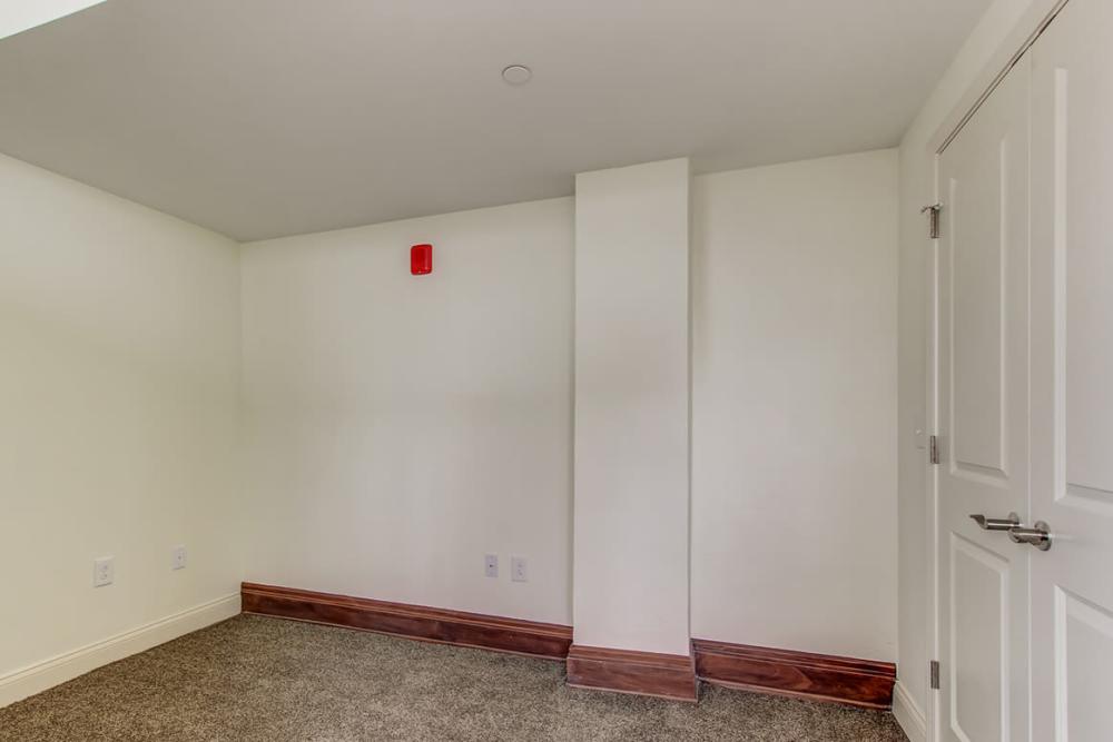 Empty room with carpeted flooring at 43 Town Square in Lima, Ohio