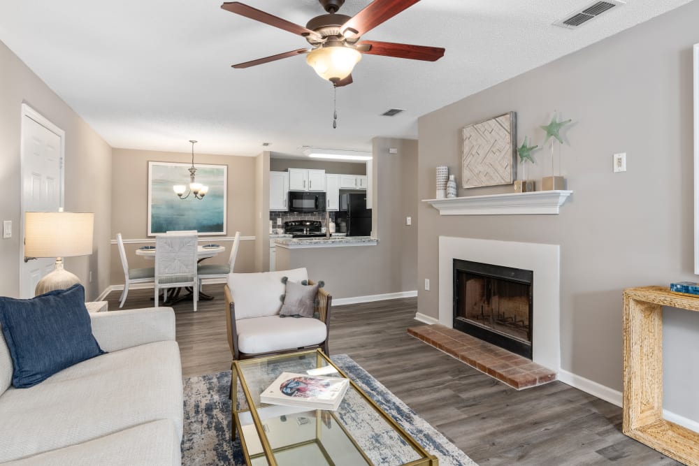 A spacious living room leading to the kitchen in an apartment at Gates at Jubilee in Daphne, Alabama