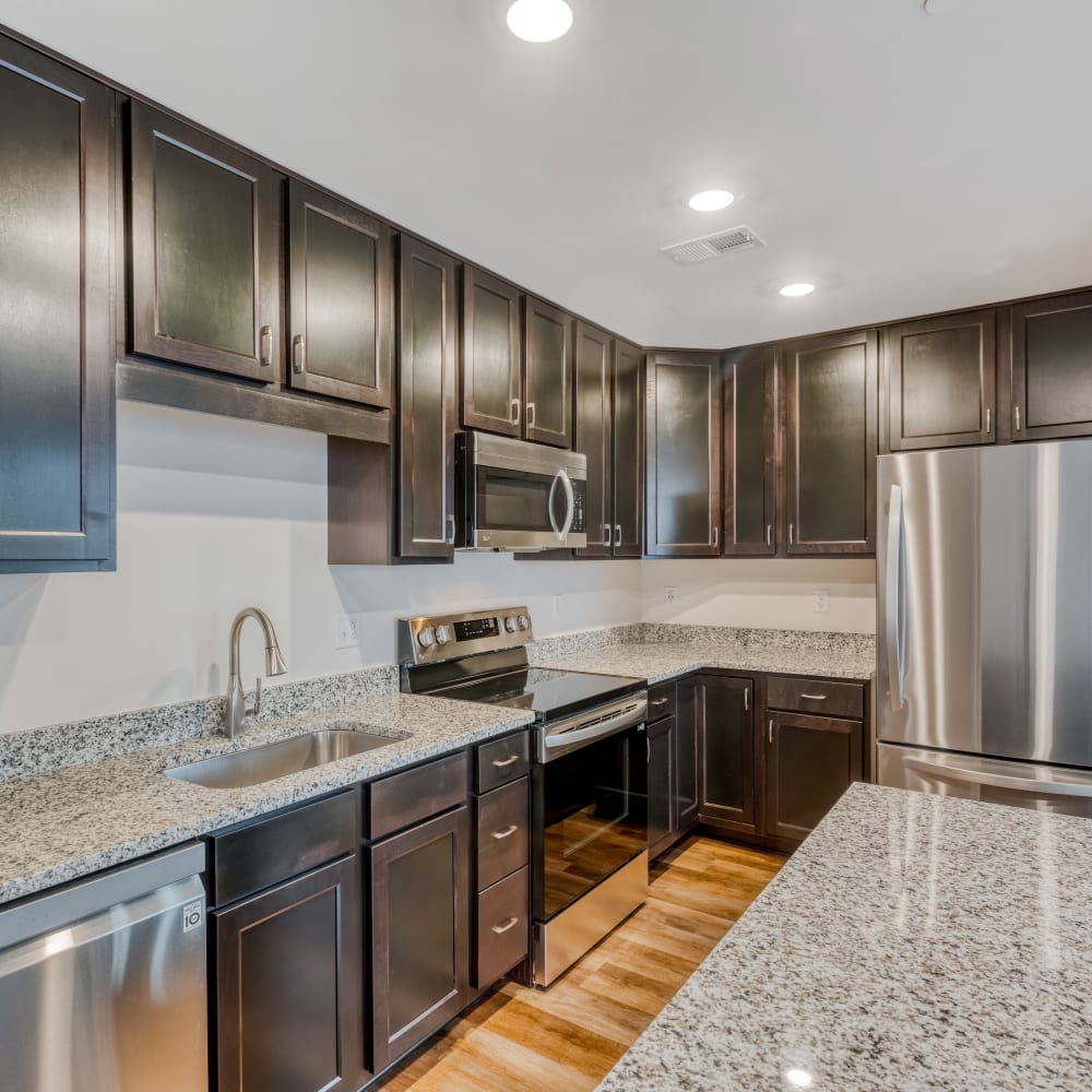 Kitchen with stainless-steel appliances and granite countertops at Fox Plan Apartments, Monroeville, Pennsylvania