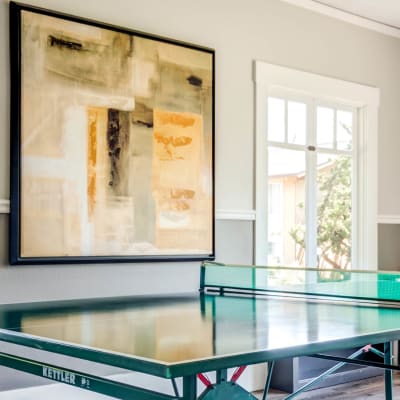 Modern art and a ping pong table in the game room at The Landmark Apartment Homes in Sunnyvale, California