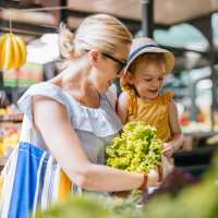 Resident with her kid shopping for fresh vegetables at Pine Creek in Paris, Texas