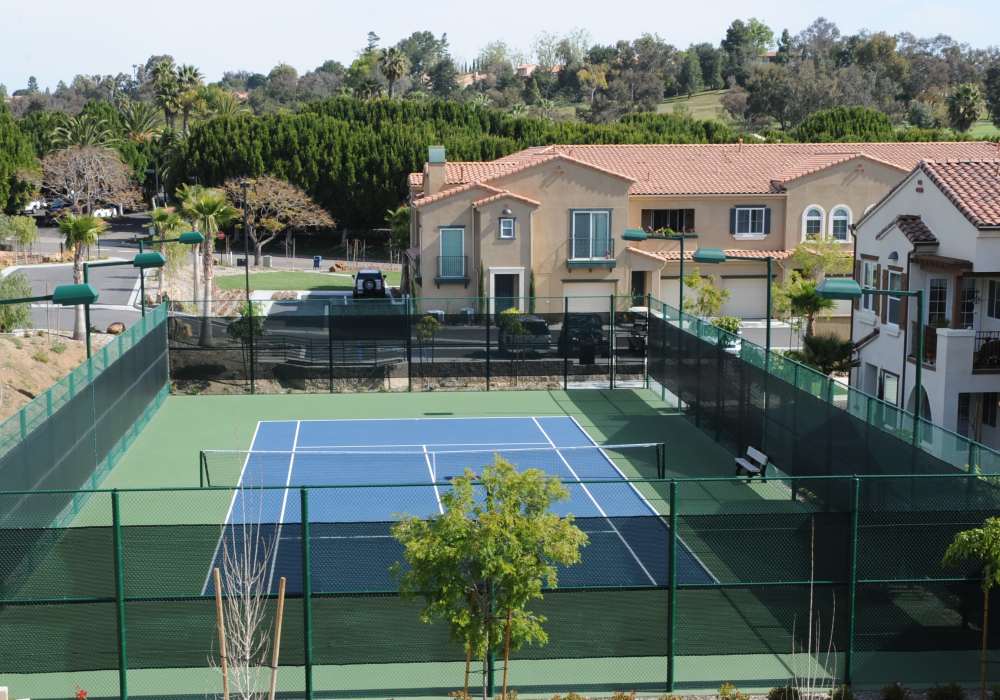 Discover this stunning property featuring a pristine tennis court surrounded by lush landscaping and elegant architecture, perfect for an active lifestyle at Cresta Bella in San Diego, California