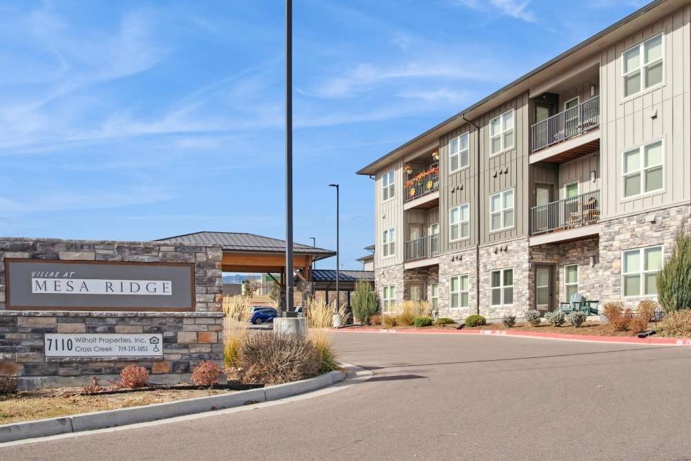 An apartment with property signage at Villas At Mesa Ridge in Fountain,Colorado