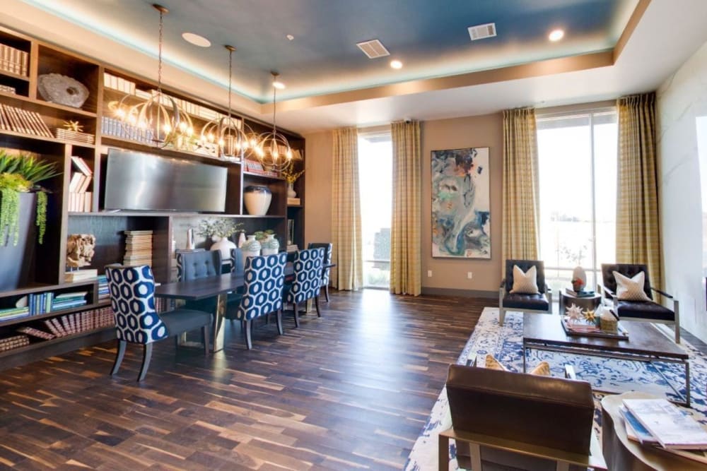 Resident lounge area with a gas fireplace and floor-to-ceiling bookcase at Argon in Oklahoma City, Oklahoma