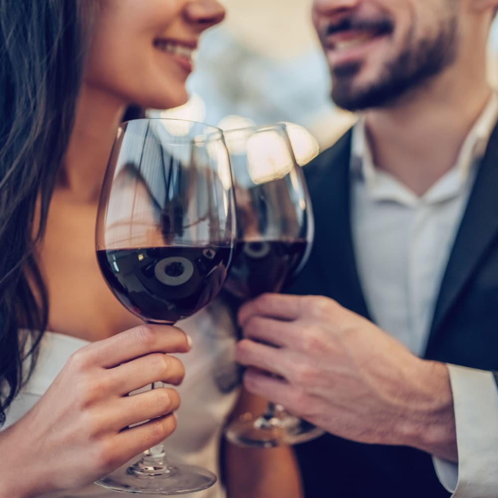 Couple raising a glass of wine to celebrate their decision to move to The Landing at Channel Islands in Oxnard, California