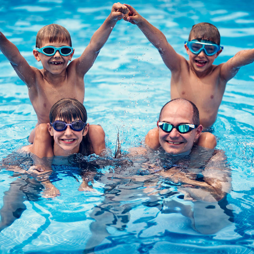 Family enjoying the refreshing swimming pool at Avilla Premier in Plano, Texas