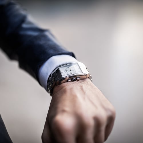 Resident checking the time on his watch near 21 West Street in New York, New York