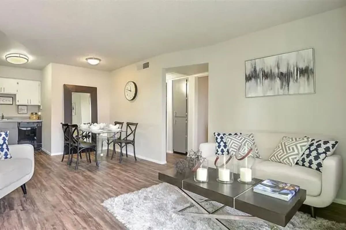 Living room and kitchen with wood-style flooring at Mesa Station Apartments in Mesa, Arizona