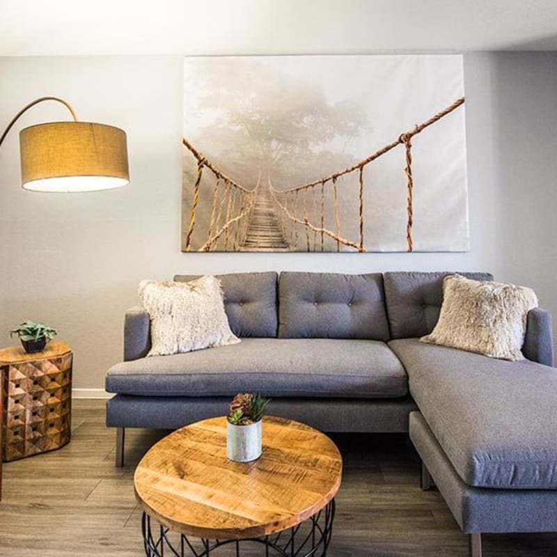 Living room with modern furniture and plank flooring at The Eleven Hundred in Sacramento, California