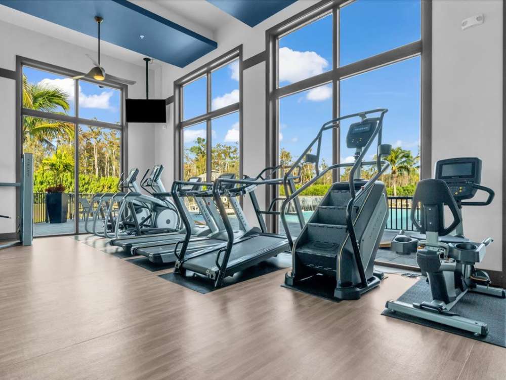 Luxury fitness center with modern equipment at 81 West Apartments in Fort Myers, Florida 