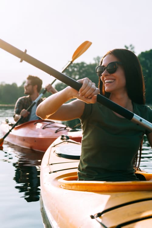 Couple on kayaks at Signature Point Apartments in League City, TX