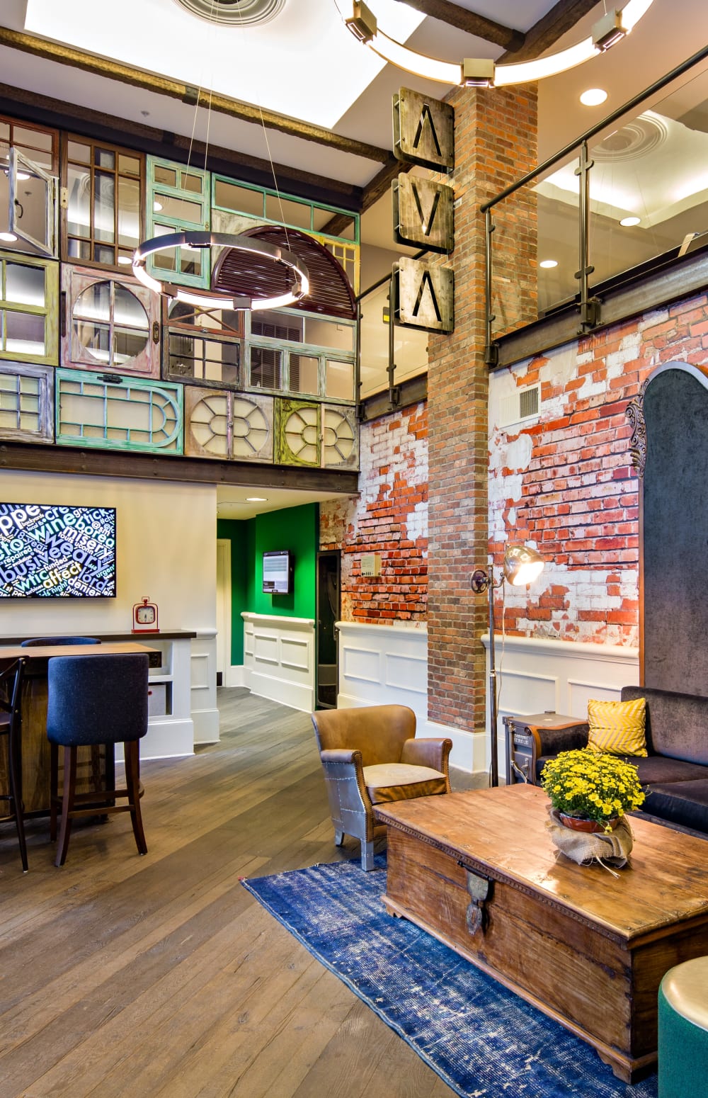 Resident clubhouse interior with exposed brick and art deco design at Sofi at 50 Forest in Stamford, Connecticut