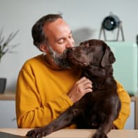 Resident with his dog at Crossbrook Apartments in Rohnert Park, California