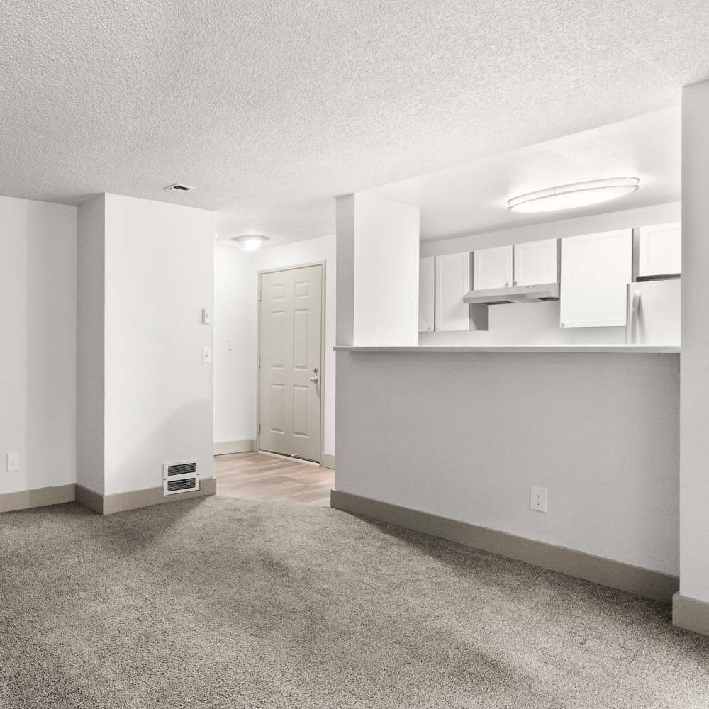 Living room with access to kitchen at Lodge at Madrona Ridge in Tacoma, Washington