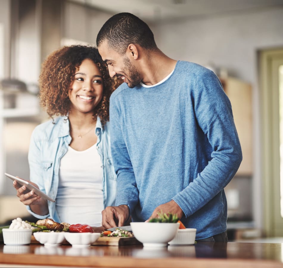 Resident couple creating a fresh meal in their new home at Sofi Ventura in Ventura, California