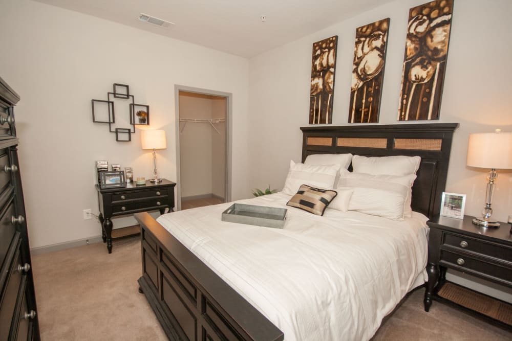 Model bedroom with a walk-in closet at Estates at McDonough Apartment Homes in McDonough, Georgia