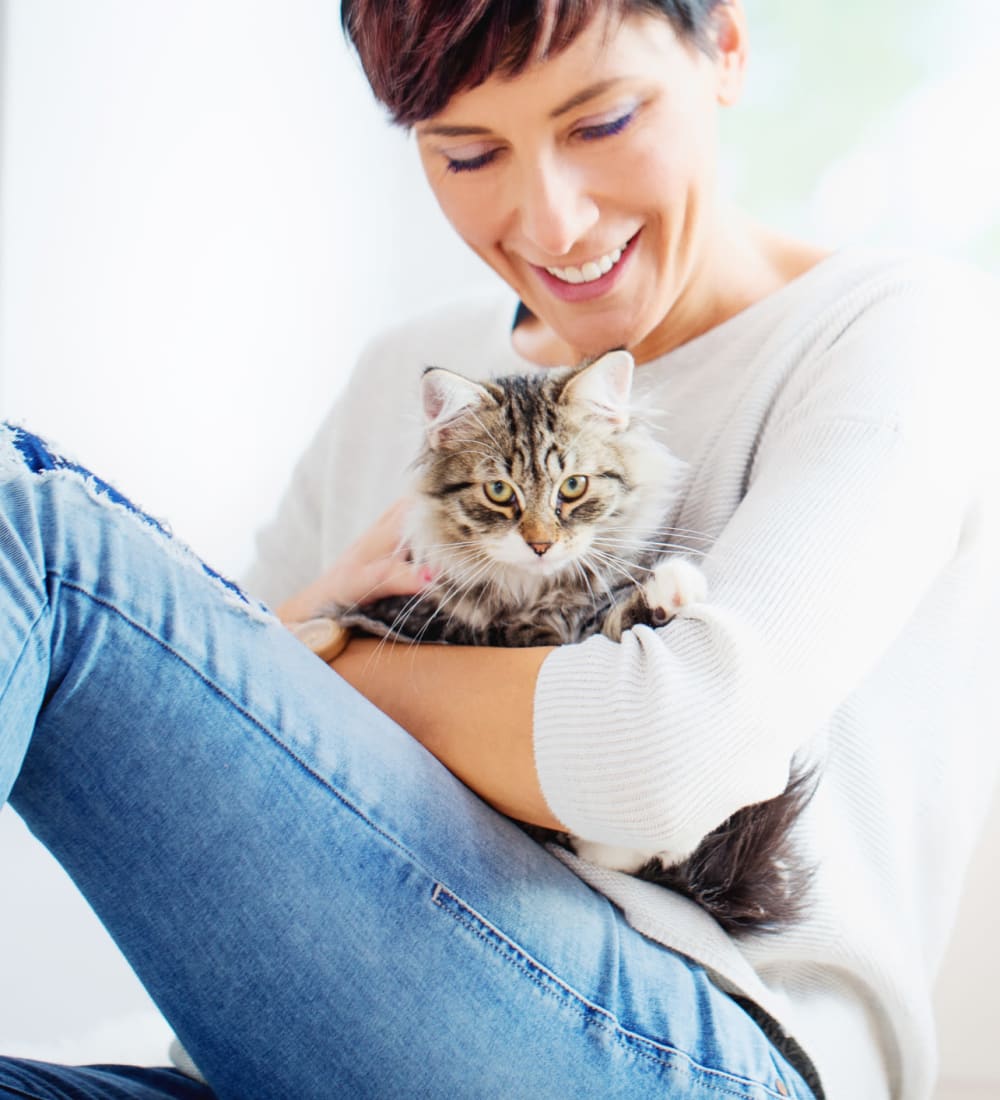 Resident holding her cat at Eagle Rock Apartments at Carle Place in Carle Place, New York