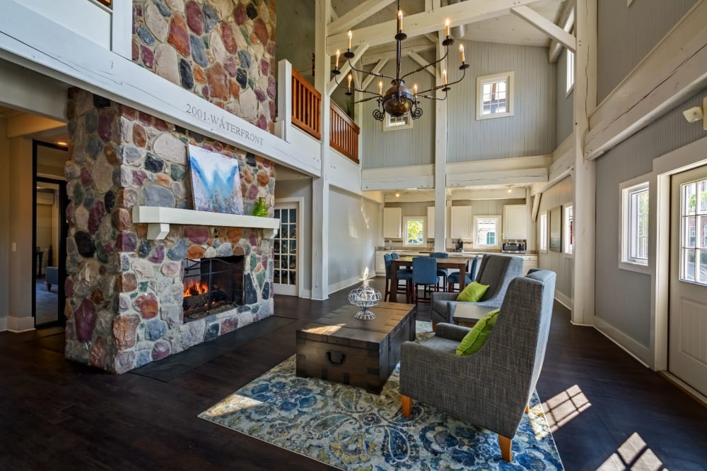 Resident clubhouse with a beautiful stone fireplace at The Waterfront Apartments & Townhomes in Munhall, Pennsylvania