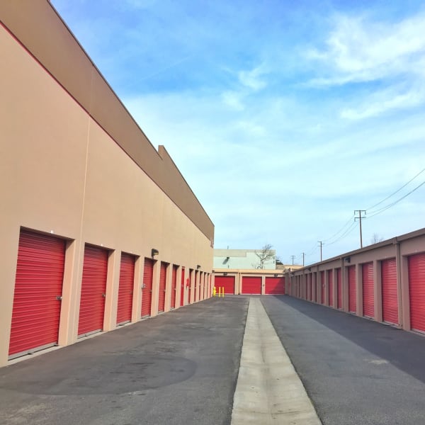 Outdoor storage units with red doors at StorQuest Self Storage in Oxnard, California