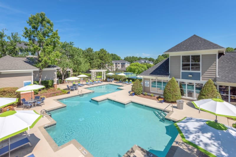 Resort-style swimming pool flanked by chaise lounge chairs and lush vegetation at The Mark in Raleigh, North Carolina