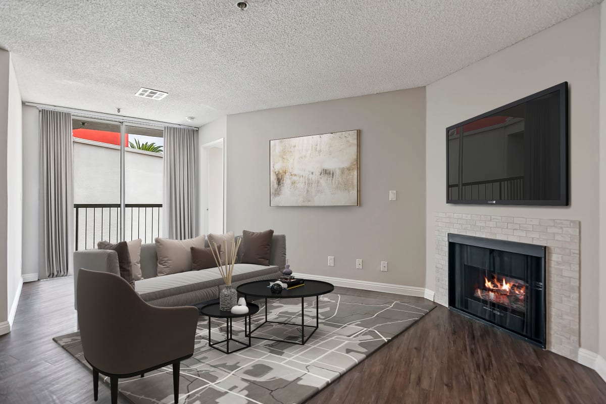 Apartment with wood-style flooring and a fireplace at Media Towers, Los Angeles, California