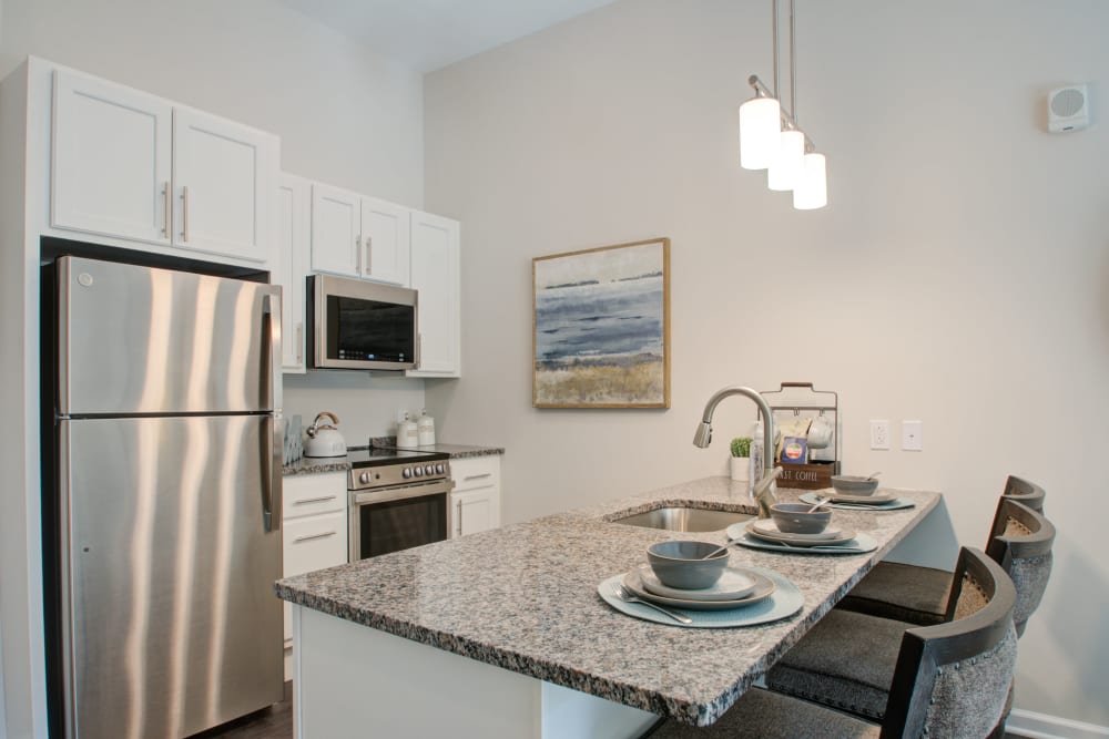 Senior apartment kitchen with stone countertops at Mercer Hill at Doylestown in Doylestown, Pennsylvania