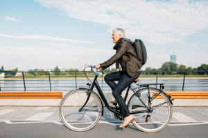 A woman riding a bicycle near Mariposa at River Bend in Georgetown, Texas